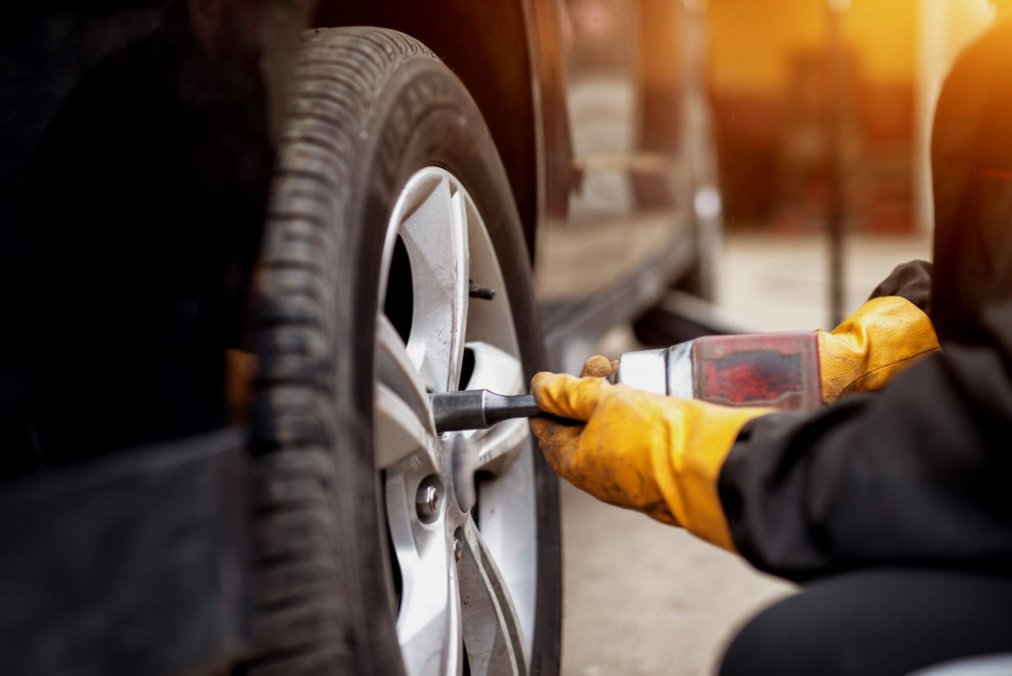 Technician working on a vehicle wheel